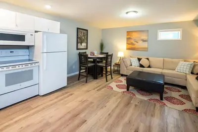a living room with a couch and a kitchen at NN - The Mack - Crestview 1-bed 1-bath in Whitehorse