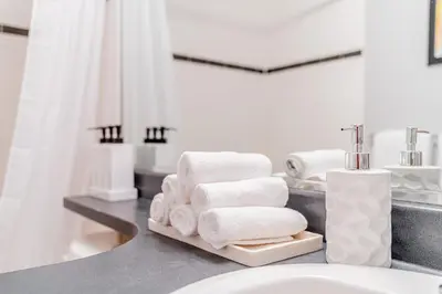 a bathroom with towels on a counter next to a sink at Near BC Place & SkyTrain Access & Free Parking in Vancouver