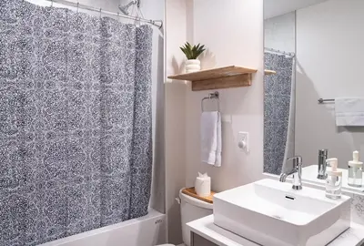 a bathroom with a shower and a white sink at Powder Pines Retreat by Revelstoke Vacations in Revelstoke