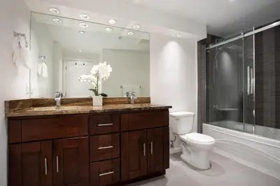 a bathroom with a sink and a toilet and a shower at Woodrun Lodge 417 | Ski-In Ski-Out, Pool, Hot Tub, Free Parking in Whistler