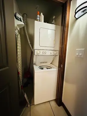 a washer and dryer in a small room at Canmore Mountain Retreat - Heated Pool & Hot-tub in Canmore