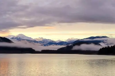 a view of a lake with mountains in the background at Romantic Off-Grid Cabin by Glacier lake in Pemberton