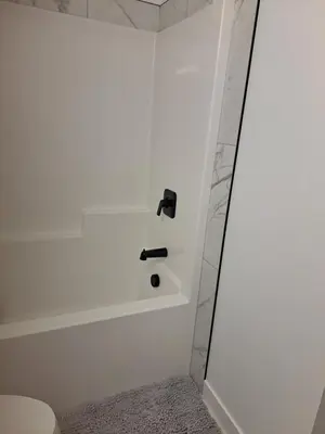 a bathroom with a bath tub and a sink at PeaceHouse for females only - Business visits in Calgary