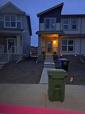 a house with a trash can in front of it at PeaceHouse for females only - Business visits in Calgary