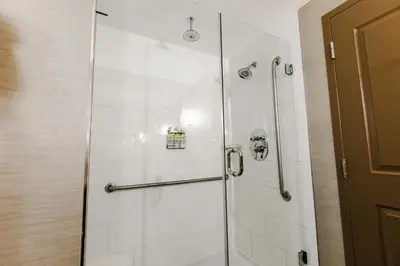 a shower with a glass door in a bathroom at Holiday Inn Express & Suites Spruce Grove - Stony Plain by IHG in Spruce Grove