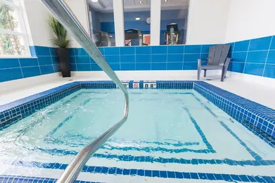 a swimming pool with a water hose at Holiday Inn Express & Suites Spruce Grove - Stony Plain by IHG in Spruce Grove