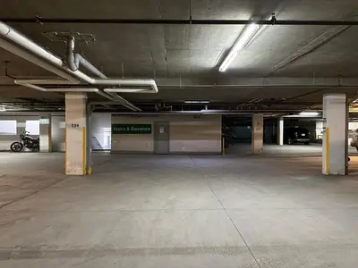 an empty parking lot with a parking garage at W400 Mountain Surround Top Floor Canmore Vacation in Canmore