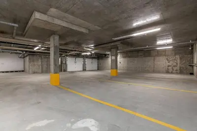 an empty parking garage with yellow columns in it at Modern Country Retreat-5 min to DTN-U/G Parking in Edmonton