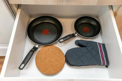 two frying pans and a cork in a drawer at Modern Country Retreat-5 min to DTN-U/G Parking in Edmonton