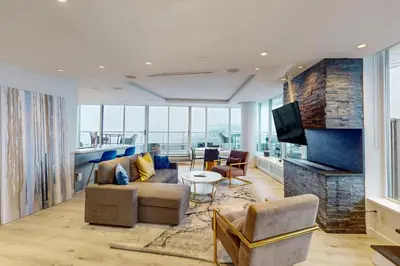 a living room with a couch and a tv at Skyline Hideaway in Vancouver