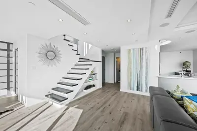 a white living room with a spiral staircase at Skyline Hideaway in Vancouver