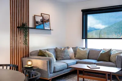 a living room with a couch and a table at Villa 23 Cabot Peaks by Revelstoke Vacations in Revelstoke