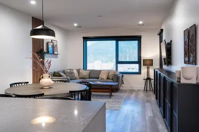 a living room with a couch and a table at Villa 23 Cabot Peaks by Revelstoke Vacations in Revelstoke