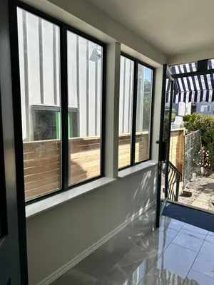 a row of windows in a room with a porch at Good Old Days Main Retro in Vancouver