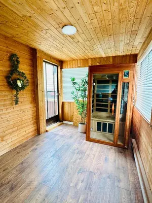an empty porch of a house with a wooden wall at Good Old Days Main Retro in Vancouver