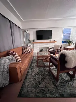 a living room with a couch and a tv at Good Old Days Main Retro in Vancouver