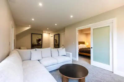 a living room with a white couch and a table at Polar Peak Lodges by Fernie Central Reservations in Fernie