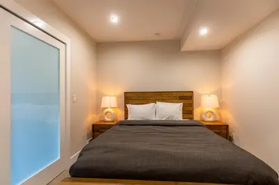 a bedroom with a large bed with two lamps at Polar Peak Lodges by Fernie Central Reservations in Fernie