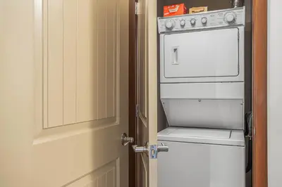 an open door to a kitchen with a white oven at Romantic Mountain Escape - Hot Tubs & Private Balcony! managed by Little Sister Getaways in Canmore