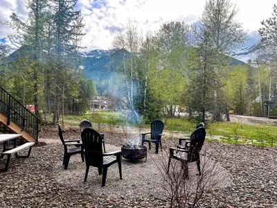 a group of chairs sitting around a fire pit at Powder House Chalet by Fernie Central Reservations in Fernie