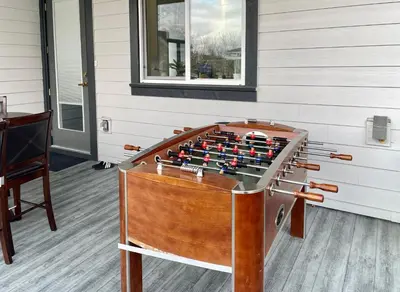 a foosball table in the corner of a room at Blissful Stay in Surrey in Surrey
