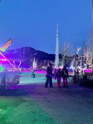 a group of people standing in front of a christmas tree at Cascade Lodge with front desk check in services, ski valet service, boot and glove dryer, 2 hot tubs, year round heated pool, gym, sauna, change rooms & showers, WIFI, cable TV in Whistler