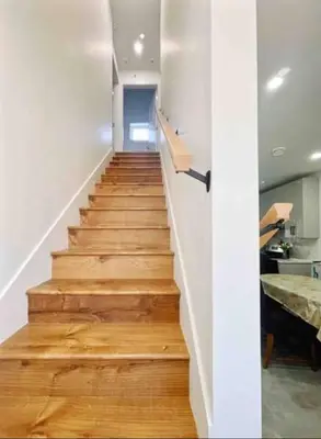 a staircase in a house with wooden floors at Vancouver’s Homey Laneway House in Vancouver
