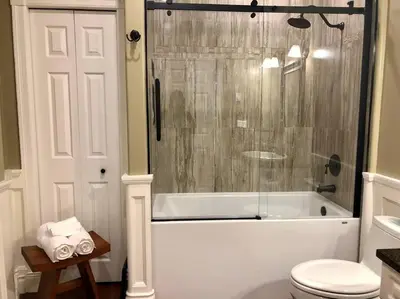 a bathroom with a tub and a toilet and a shower at Upscale Character Home with Luxurious Amenities in Victoria
