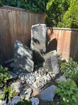 a garden with rocks and a wooden fence at Upscale Character Home with Luxurious Amenities in Victoria