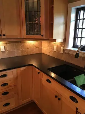 a kitchen with a black counter top and a sink at Character Stay across Swan Lake Nature Sanctuary in Victoria