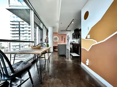 a kitchen and dining room with a table and chairs at ColoursNest - Downtown apt spectacular view and location in Calgary