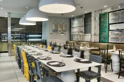 a dining room with a long table and chairs at ColoursNest - Downtown apt spectacular view and location in Calgary