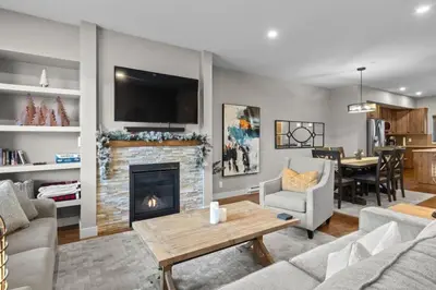 a living room with a fireplace and a tv at Echo Landing #20 townhouse in Sun Peaks