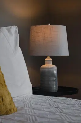 a lamp sitting on a table next to a bed at Echo Landing #20 townhouse in Sun Peaks
