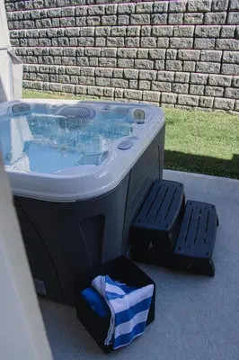 a hot tub sitting in front of a brick wall at Echo Landing #20 townhouse in Sun Peaks