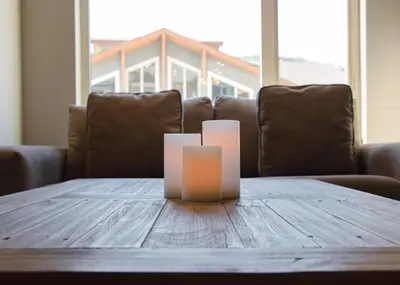 a wooden table with two candles on top of it at Echo Landing #20 townhouse in Sun Peaks