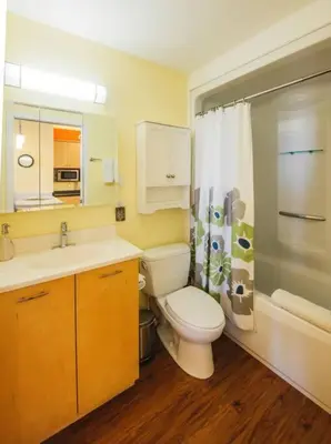 a bathroom with a toilet and a sink and a shower at The Niven Lake Retreat in Yellowknife