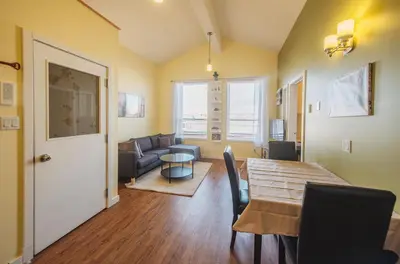 a living room with a table and a couch at The Niven Lake Retreat in Yellowknife