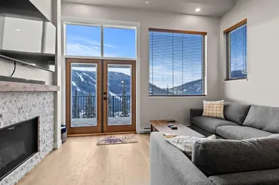 a living room with a couch and a fireplace at Powder Heights #18 townhouse in Sun Peaks