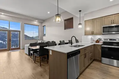 a kitchen and dining room with a table and chairs at Powder Heights #18 townhouse in Sun Peaks