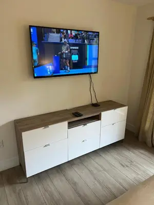 a flat screen tv on top of a white entertainment center at Beautiful 1BR 1BA Apartment at NORTHSTAR-Whistler, BC in Whistler