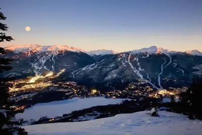 a view of a city in the mountains with the moon at Beautiful 1BR 1BA Apartment at NORTHSTAR-Whistler, BC in Whistler