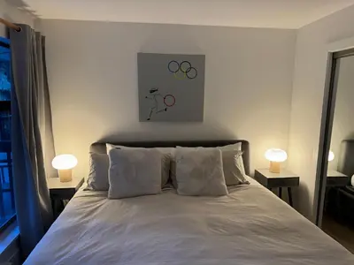 a bedroom with a bed with two lamps on two tables at Beautiful 1BR 1BA Apartment at NORTHSTAR-Whistler, BC in Whistler
