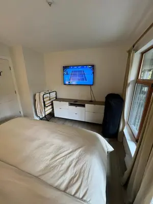 a bedroom with a bed and a flat screen tv at Beautiful 1BR 1BA Apartment at NORTHSTAR-Whistler, BC in Whistler