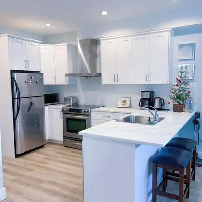a kitchen with white cabinets and a christmas tree in it at Ground level two bedrooms Suite near Lake and Golf Course in Victoria