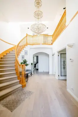 a large hallway with a staircase and a chandelier at Richmond Cozy Place 2 in Richmond