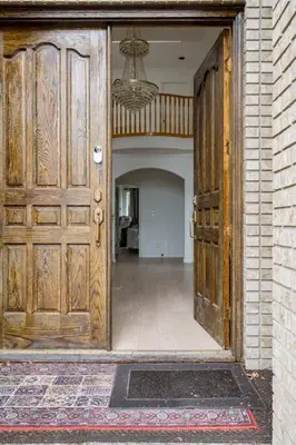 a large wooden door in a room with a hallway at Richmond Cozy Place 2 in Richmond