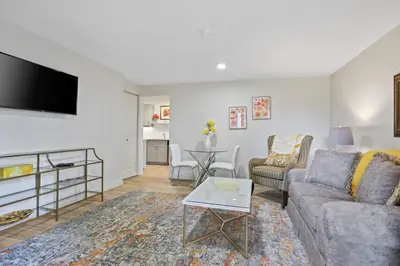 a living room with a couch and a tv at Uncork and Unwind in West Kelowna