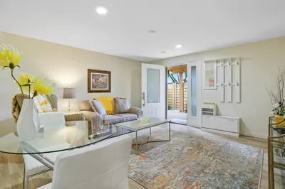 a living room with a couch and a glass table at Uncork and Unwind in West Kelowna