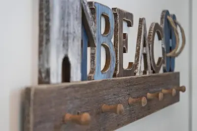 a wooden shelf with the words dad on a wall at Beachfront Villa #14 at The Beach House in Campbell River